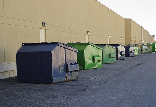 a row of industrial dumpsters at a construction site in Cheswold